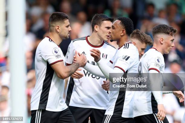 Aleksandar Mitrovic of Fulham celebrates with teammates after scoring the team's first goal during the Premier League match between Fulham FC and...