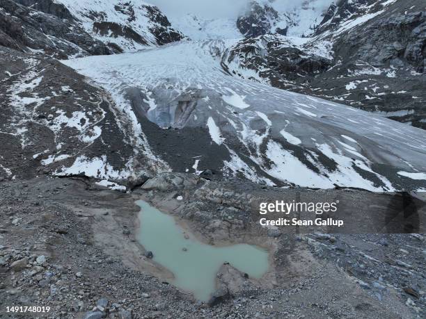 In this aerial view a pond of meltwater lies below the receding Morteratsch glacier on May 20, 2023 near Pontresina, Switzerland. On June 18 Swiss...