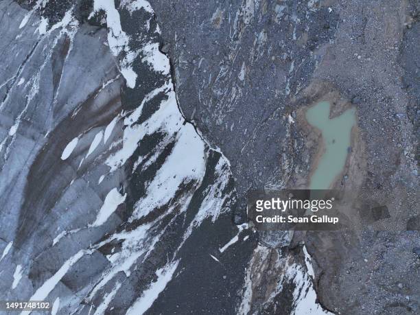In this aerial view a pond of meltwater lies next to the receding Morteratsch glacier on May 20, 2023 near Pontresina, Switzerland. On June 18 Swiss...