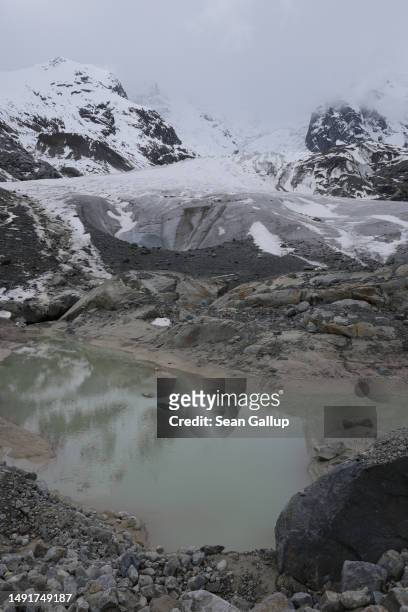 Pond of meltwater lies below the receding Morteratsch glacier on May 20, 2023 near Pontresina, Switzerland. On June 18 Swiss voters will go to the...