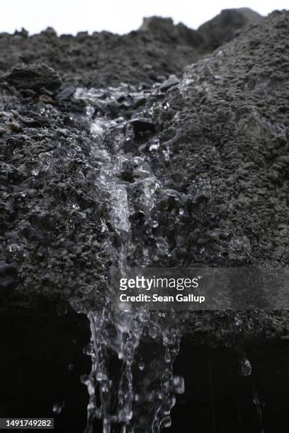 Meltwater runs down a dirt-covered portion of the receding Morteratsch glacier on May 20, 2023 near Pontresina, Switzerland. On June 18 Swiss voters...