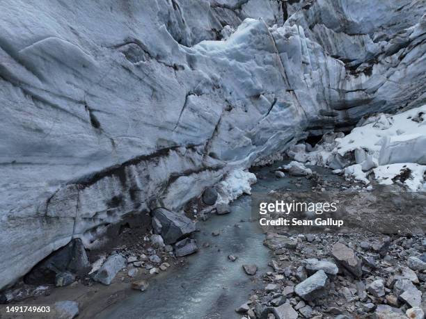 In this aerial view a small river of meltwater flows from a collapsed portion of the receding Morteratsch glacier on May 20, 2023 near Pontresina,...