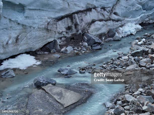 In this aerial view a small river of meltwater flows from a collapsed portion of the receding Morteratsch glacier on May 20, 2023 near Pontresina,...