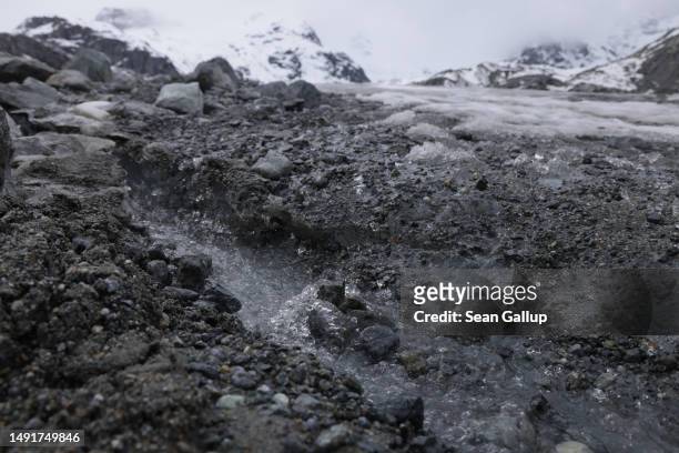 Meltwater runs down a dirt-covered portion of the receding Morteratsch glacier on May 20, 2023 near Pontresina, Switzerland. On June 18 Swiss voters...