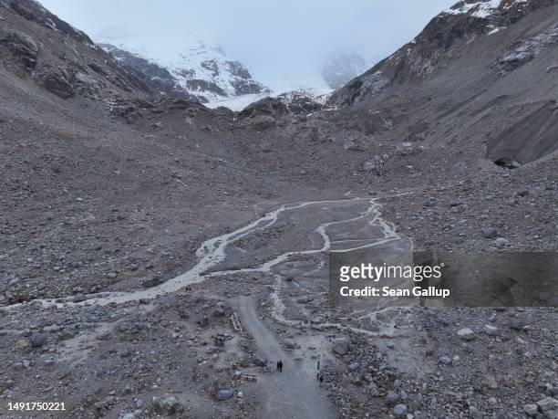 In this aerial view a river of meltwater runs through a basin of the receding Morteratsch glacier once filled completely in 2015 on May 20, 2023 near...