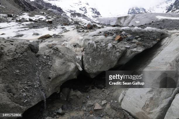 Meltwater trickles down a dirt-covered portion of the receding Morteratsch glacier on May 20, 2023 near Pontresina, Switzerland. On June 18 Swiss...