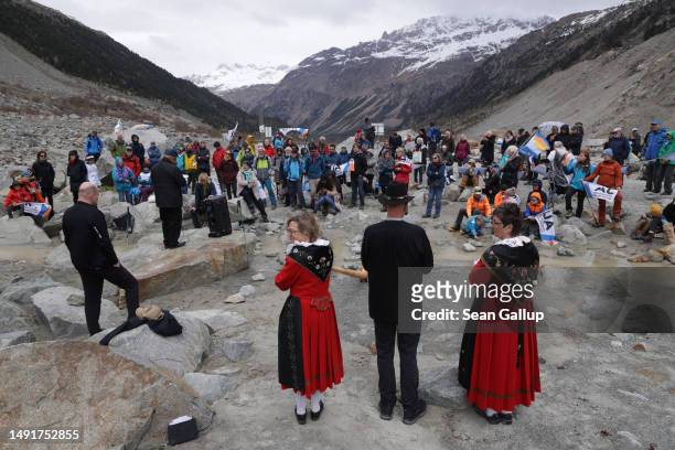 Climate activists gather with banners below the receding Morteratsch glacier to campaign for an upcoming climate-related referendum on May 20, 2023...