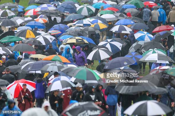General view of fans as they use umbrellas in the rain during the third round of the 2023 PGA Championship at Oak Hill Country Club on May 20, 2023...