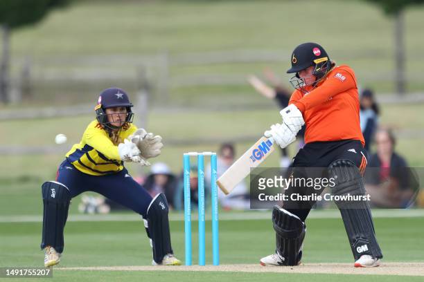 Georgie Boyce of Blaze hits out while South East Stars Kira Chathli tends the wicket during the Charlotte Edwards Cup match between South East Stars...
