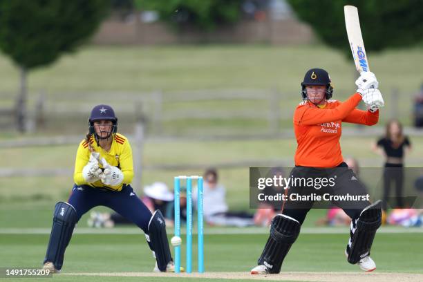 Georgie Boyce of Blaze hits out while South East Stars Kira Chathli tends the wicket during the Charlotte Edwards Cup match between South East Stars...