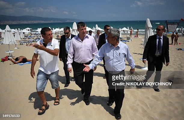 Israel's Tourism Minister Stas Misezhnikov walks along the beach in Burgas, a sunny resort town where five Israelis were killed in a suicide blast...