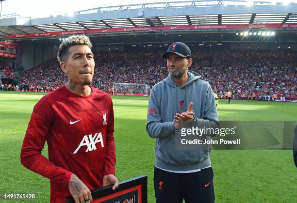 Jurgen Klopp manager of Liverpool with Roberto Firmino of Liverpool at the end of the Premier League match between Liverpool FC and Aston Villa at...