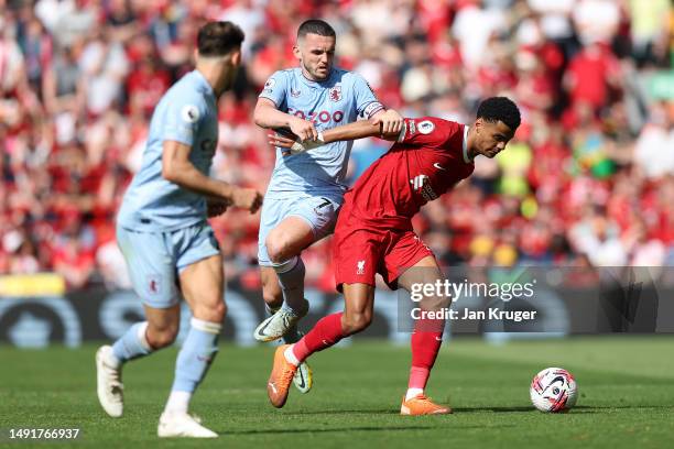 Cody Gakpo of Liverpool battles with John McGinn of Aston Villa during the Premier League match between Liverpool FC and Aston Villa at Anfield on...