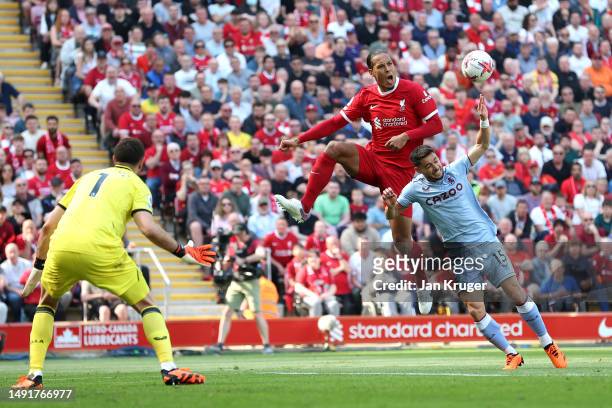 Virgil van Dijk of Liverpool and Alex Moreno of Aston Villa challenge for the ball during the Premier League match between Liverpool FC and Aston...
