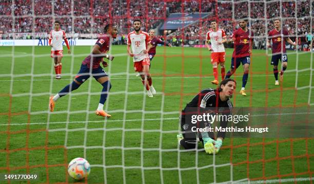 Yann Sommer of FC Bayern Munich reacts as Christopher Nkunku of RB Leipzig celebrates after scoring his team's second goal from a penalty kick during...