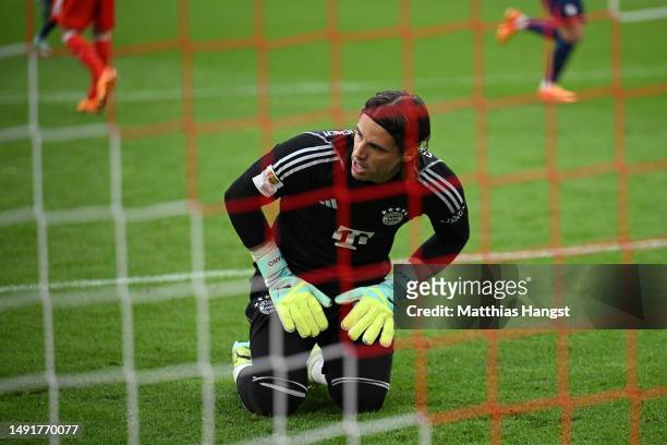Yann Sommer of FC Bayern Munich reacts after failing to save a penalty kick from Christopher Nkunku of RB Leipzig as they score the team's second...