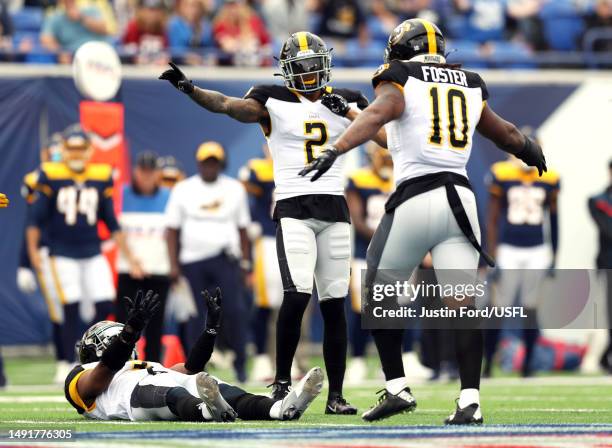 Arnold Tarpley III and Reuben Foster of the Pittsburgh Maulers react after breaking up a pass intended for Vinny Papale of the Memphis Showboats...