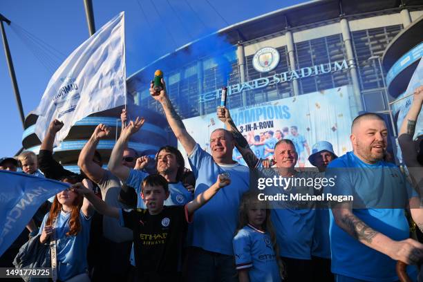 Manchester City fans celebrate with a flag after their side were crowned 2022/23 Premier League champions as Nottingham Forest beat Arsenal, at...