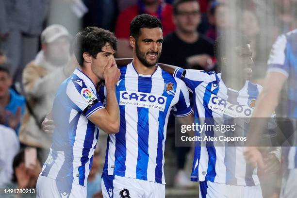 Mikel Merino of Real Sociedad celebrates with teammates after scoring the team's first goal during the LaLiga Santander match between FC Barcelona...