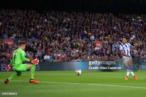 Mikel Merino of Real Sociedad scores the team's first goal as Marc-Andre ter Stegen of FC Barcelona attempts to make a save during the LaLiga...