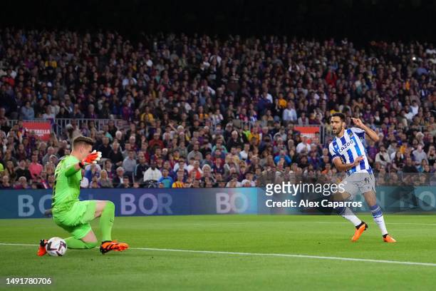 Mikel Merino of Real Sociedad scores the team's first goal as Marc-Andre ter Stegen of FC Barcelona attempts to make a save during the LaLiga...