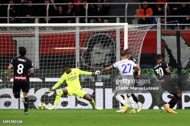 Mike Maignan of AC Milan attempts to make a save as Fabio Quagliarella of UC Sampdoria scores the team's first goal during the Serie A match between...