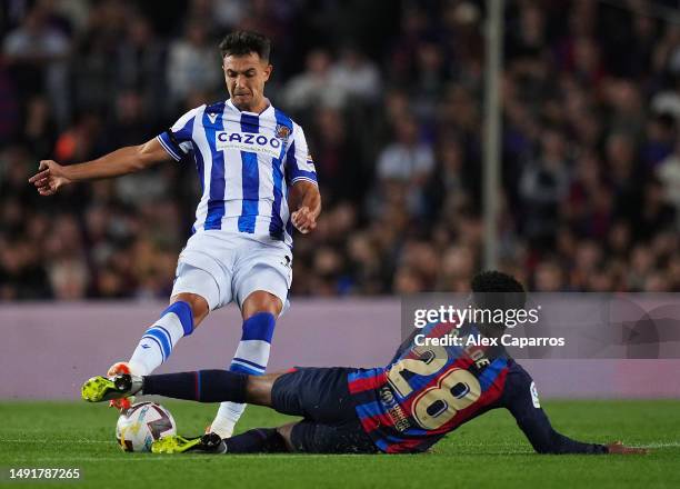 Martin Zubimendi of Real Sociedad is challenged by Alejandro Balde of FC Barcelona during the LaLiga Santander match between FC Barcelona and Real...