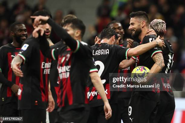 Olivier Giroud of AC Milan celebrates with teammates after scoring the team's fifth goal, his third goal of the match and hat-trick goal, during the...