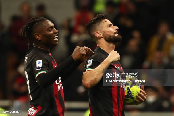 Olivier Giroud of AC Milan celebrates with teammates after scoring the team's fifth goal, his third goal of the match and hat-trick goal, during the...