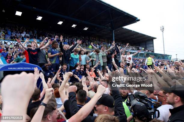 Carlisle United players celebrate victory with fans on the pitch following the Sky Bet League Two Play-Off Semi-Final Second Leg match between...