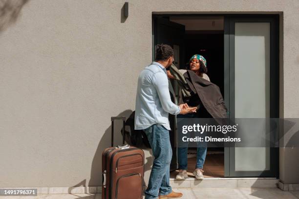 couple fighting outside home. - fight for life stock pictures, royalty-free photos & images