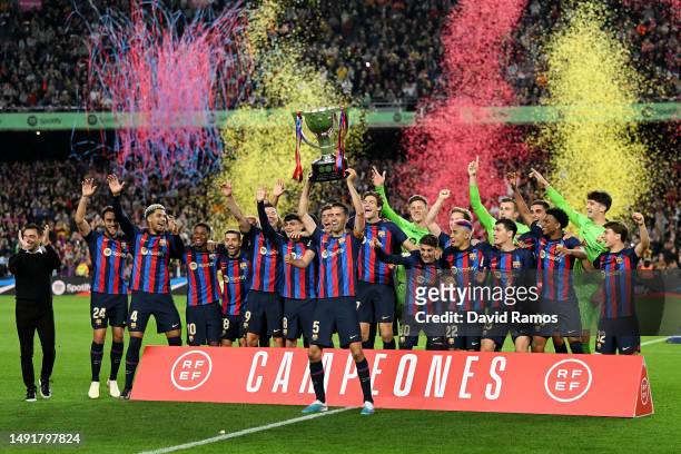 Sergio Busquets of FC Barcelona lifts the LaLiga Santander Trophy as players of FC Barcelona celebrate after being crowned League Champions after the...