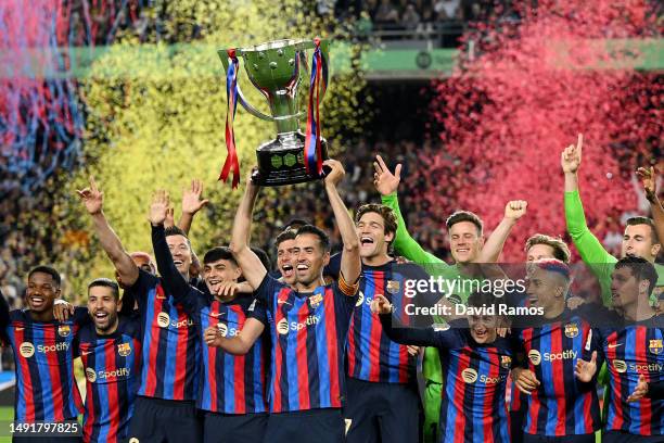 Sergio Busquets of FC Barcelona lifts the LaLiga Santander Trophy as players of FC Barcelona celebrate after being crowned League Champions after the...