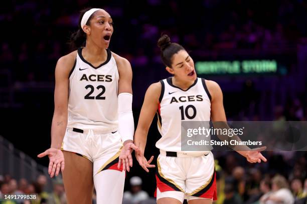 Ja Wilson and Kelsey Plum of the Las Vegas Aces react during the third quarter against the Seattle Storm at Climate Pledge Arena on May 20, 2023 in...