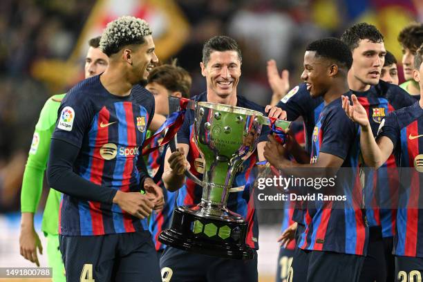 Ronald Araujo, Robert Lewandowski and Ansu Fati of FC Barcelona celebrate with the La Liga trophy during the LaLiga Santander match between FC...