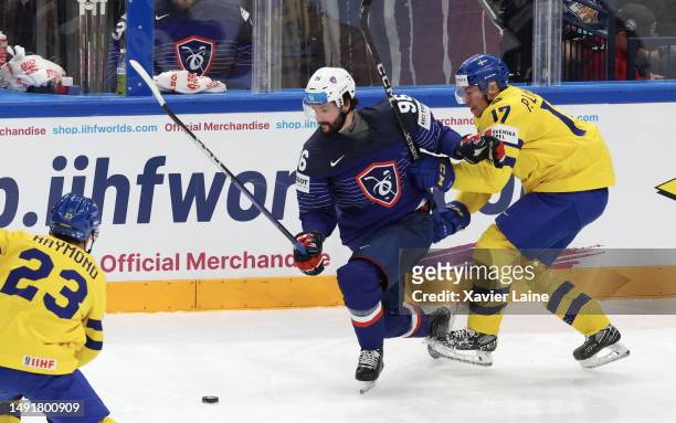 Loic Farnier of Team France in action with Par Lindholm of Team Sweden during the 2023 IIHF Ice Hockey World Championship Finland - Latvia game...