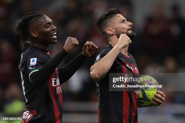 Olivier Giroud of AC Milan holds the matchball as he celebrates with team mate Rafael Leao after scoring to complete his hat-trick the Serie A match...