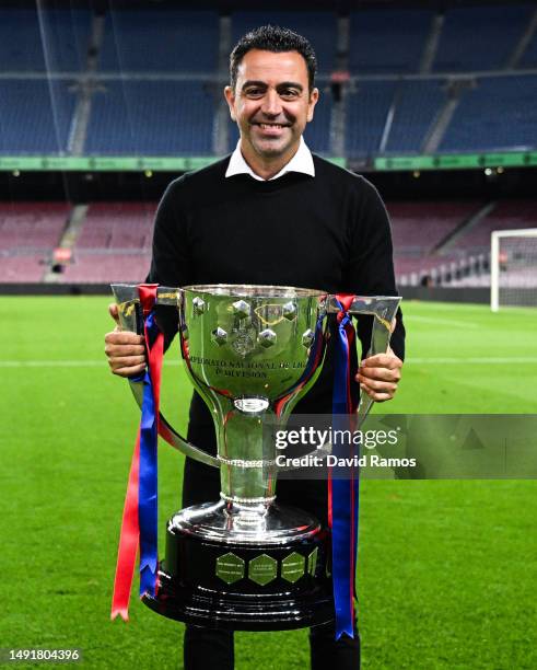 Head Coach Xavi Hernandez of FC Barcelona poses with La Liga trophy after the LaLiga Santander match between FC Barcelona and Real Sociedad at...