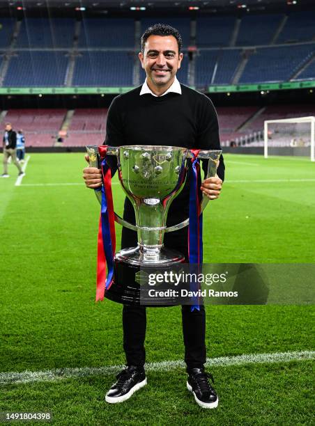 Head Coach Xavi Hernandez of FC Barcelona poses with La Liga trophy after the LaLiga Santander match between FC Barcelona and Real Sociedad at...