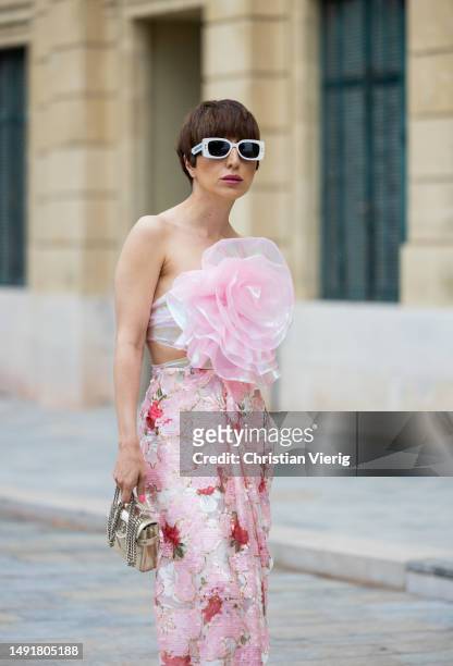 Salome Chaboki wears pink sequin maxi skirt by Anne Fontaine, pink Organza floral top by Anne Fontaine, golden mini bag by Balmain, golden sandals by...