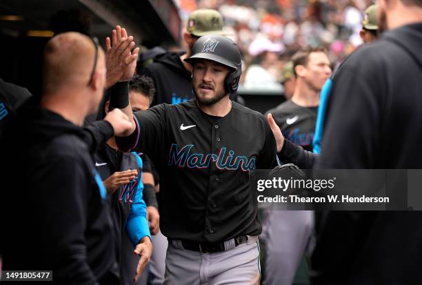 Garrett Hampson of the Miami Marlins is congratulated by teammates after he scored against the San Francisco Giants in the top of the eighth inning...