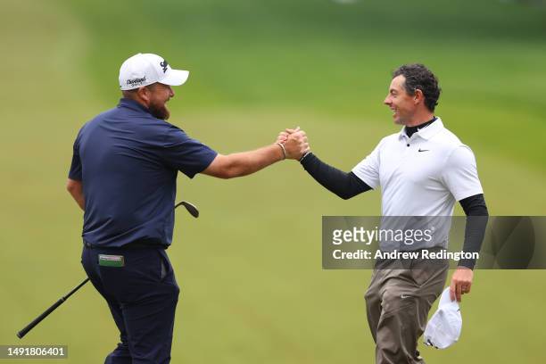 Shane Lowry of Ireland shakes hands with Rory McIlroy of Northern Ireland on the 18th green during the third round of the 2023 PGA Championship at...