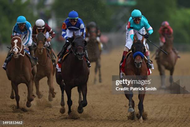 Jockey John Velazquez riding National Treasure crosses the finish line to win the 148th Running of the Preakness Stakes at Pimlico Race Course on May...