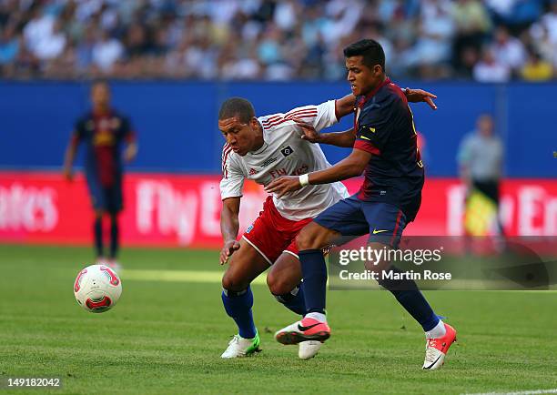 Jeffrey Bruma of Hamburg and Alexis Sanchez of Barcelona battle for the ball during the friendly match between Hamburger SV and FC barcelona at...