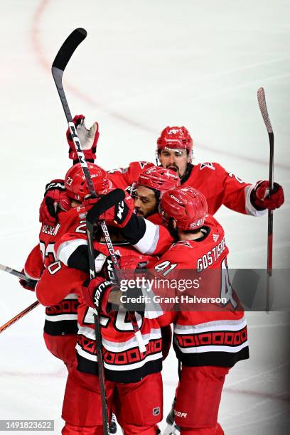 Jalen Chatfield of the Carolina Hurricanes celebrates with his teammates after scoring a goal on Sergei Bobrovsky of the Florida Panthers during the...