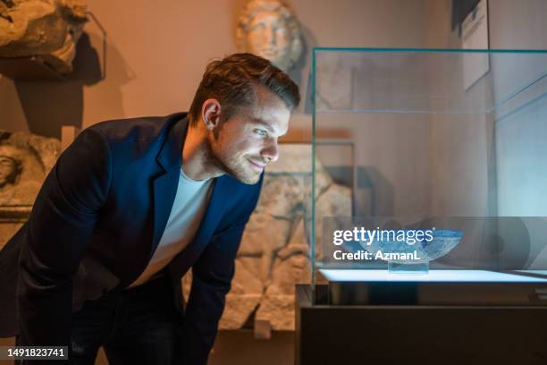 the light of history on a man's face - museum sculpture stock pictures, royalty-free photos & images