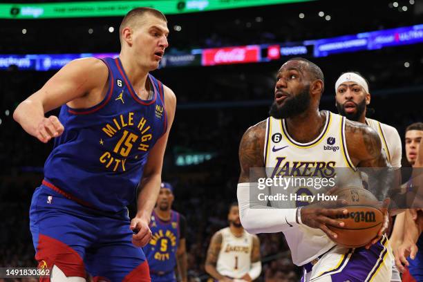 LeBron James of the Los Angeles Lakers drives to the basket against Nikola Jokic of the Denver Nuggets during the first quarter in game three of the...