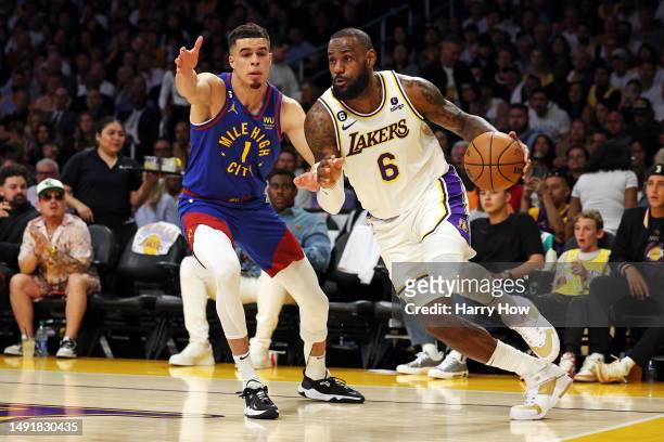 LeBron James of the Los Angeles Lakers drives to the basket against Michael Porter Jr. #1 of the Denver Nuggets during the first quarter in game...
