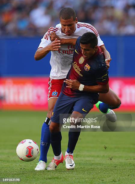 Jeffrey Bruma of Hamburg and Alexis Sanchez of Barcelona battle for the ball during the friendly match between Hamburger SV and FC barcelona at...