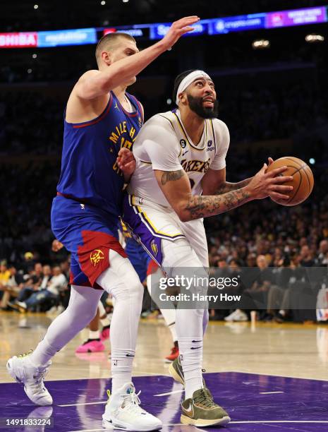 Anthony Davis of the Los Angeles Lakers drives to the basket against Nikola Jokic of the Denver Nuggets during the first quarter in game three of the...